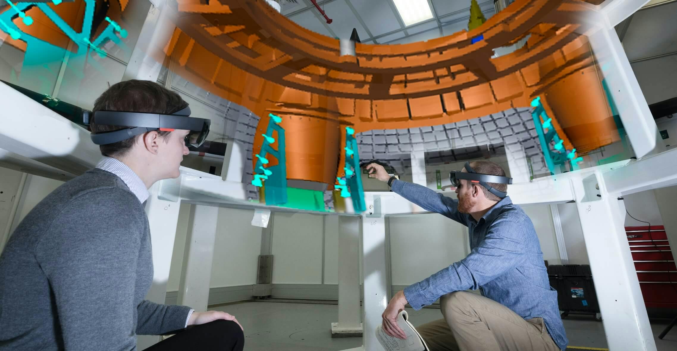 Two people wearing VR headsets collaborating on a project
